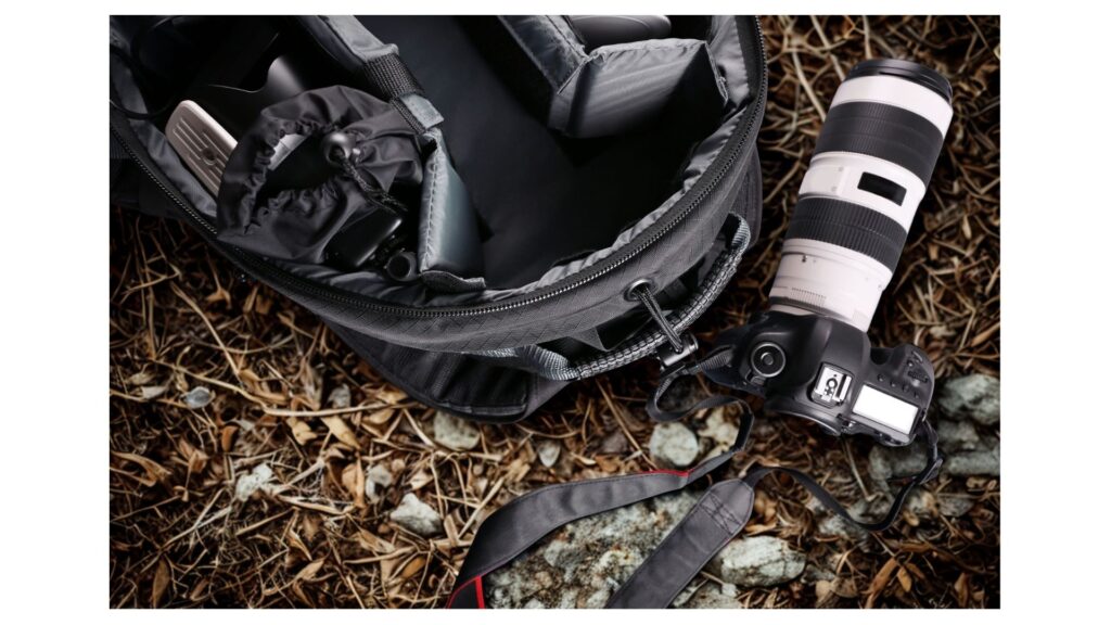 Camera Bag and camera on a forest floor