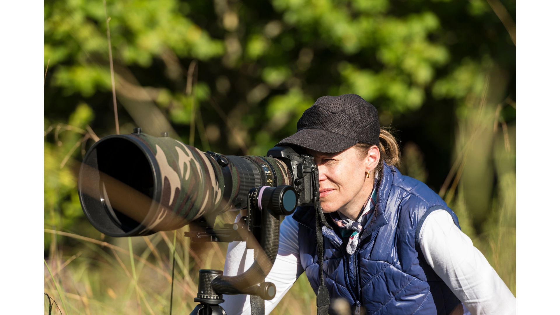 Image of photographer using a tripod suitable for Wildlife Photography